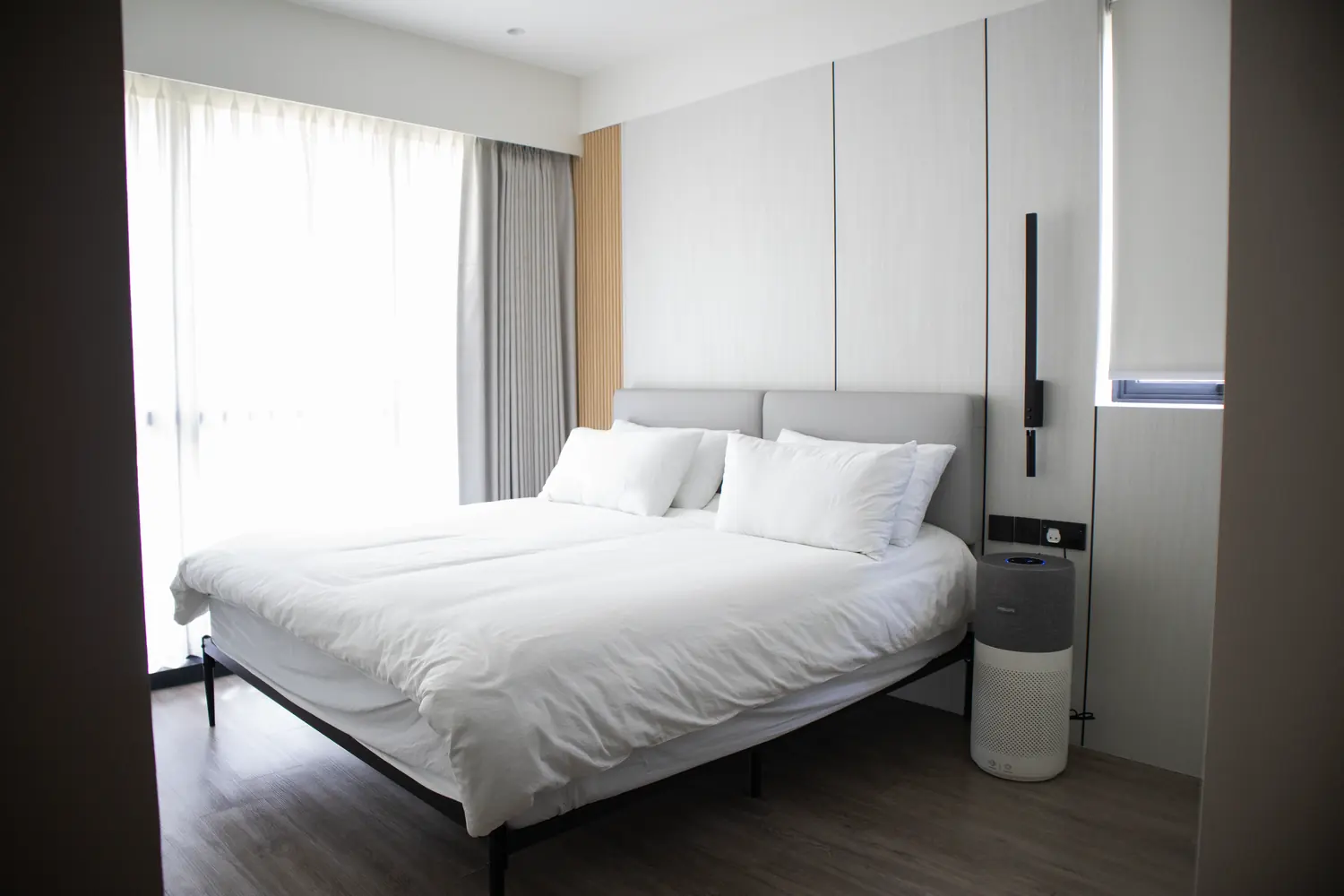 The bedroom, fluted oak headboard panelling and integrated linear lighting